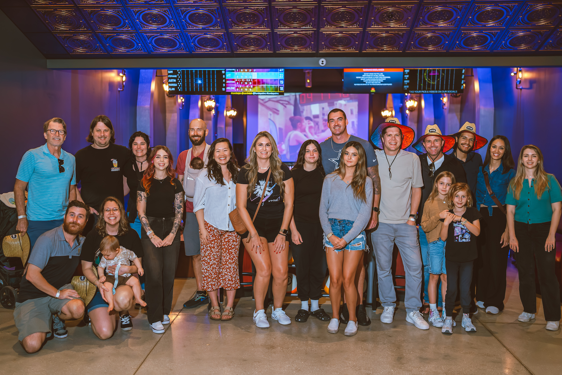 A team celebrating together at a company event with families included — culture in action