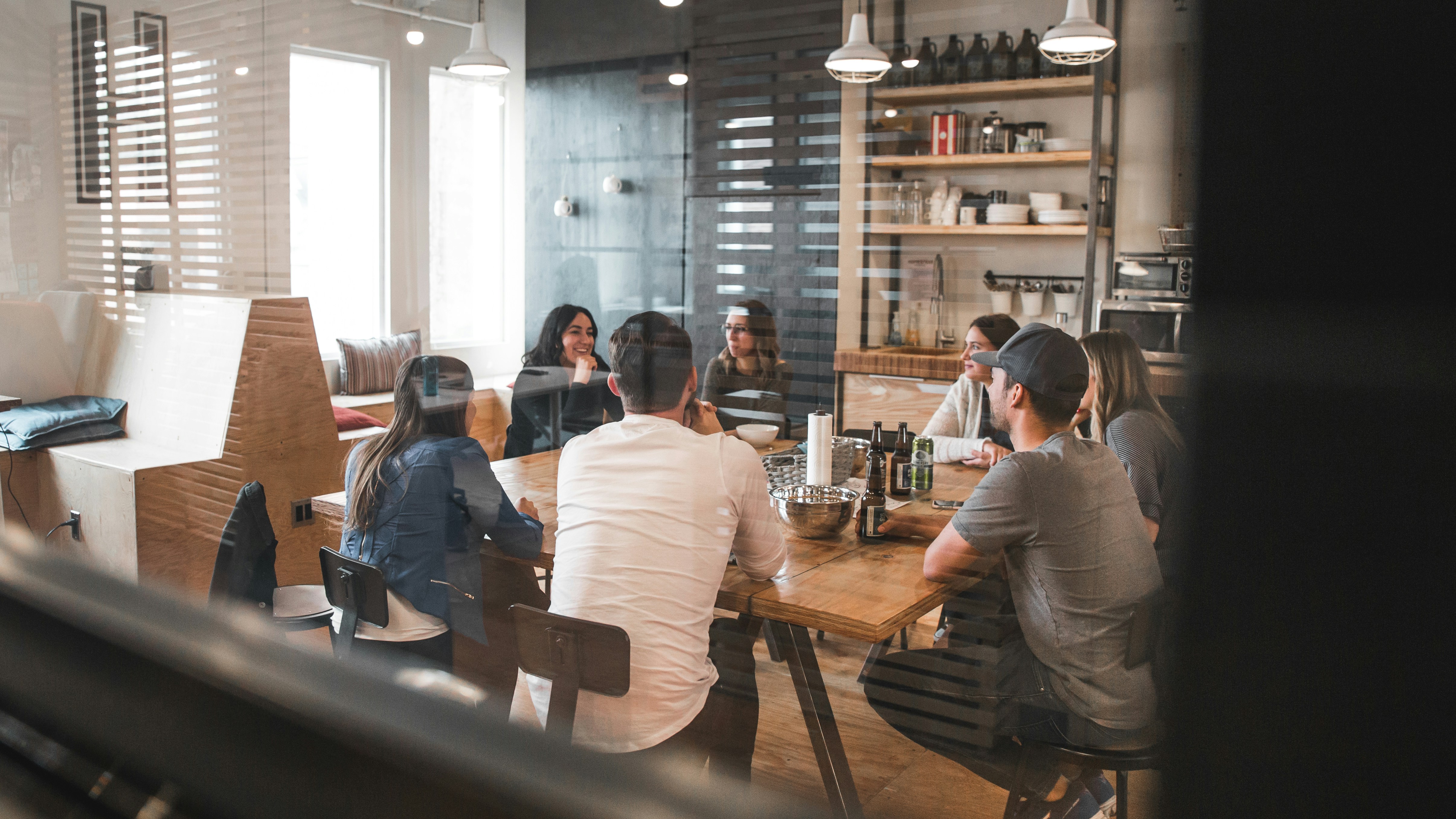 Team gathered around a table in honest conversation