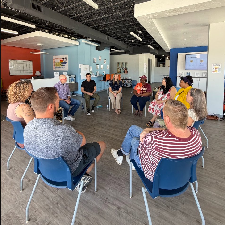 A team sitting together in a circle having an open, honest conversation